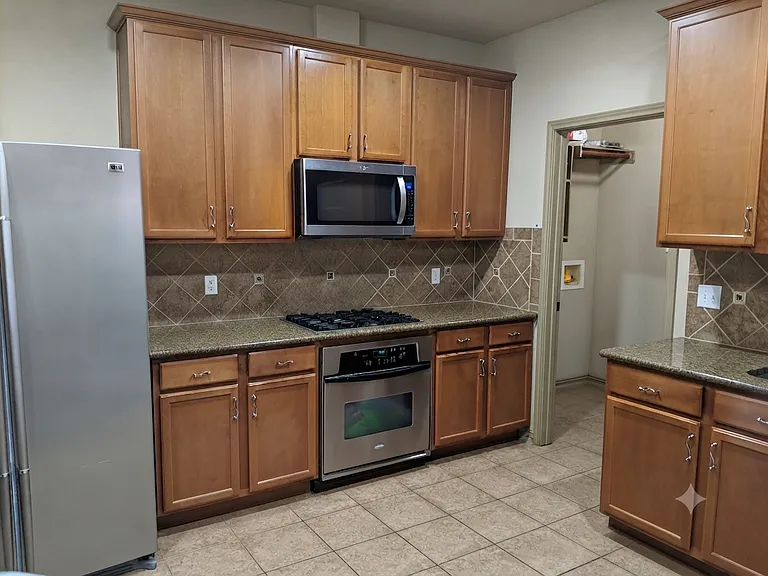 Kitchen with brand new 4 door stainless steel refrigerator