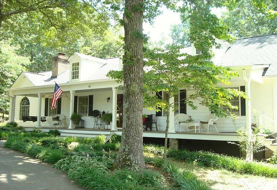 Traditional Cape Cod with circular drive and 2 car detached garage