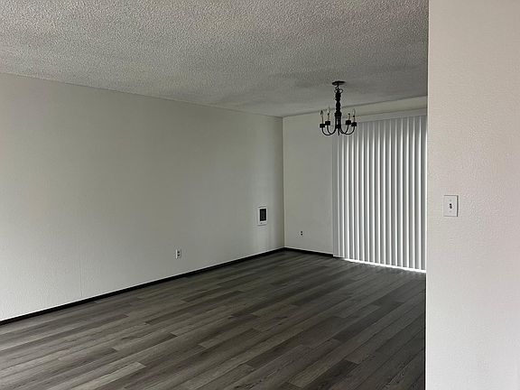 new wood floors in living / dining room with kitchen to the side also leading to the backyard