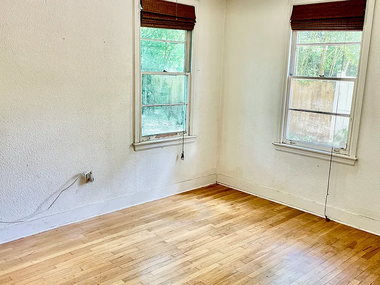 Bedroom with hardwood floors and walk-in closet.