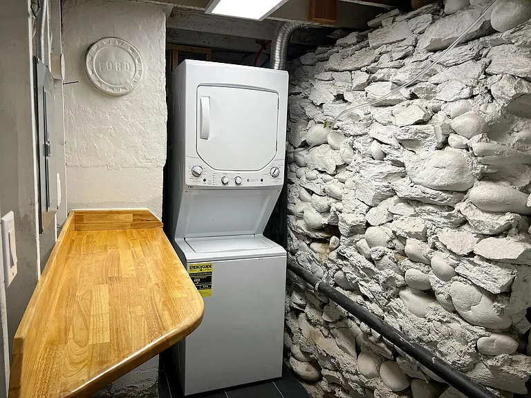 Private utility room (not shared) with brand new washer and dryer, with real wood utility table for clothes folding and storage