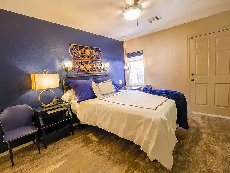 Second bedroom, queen size adjustable mattress, side table with chair, 60" TV, closet with drawers