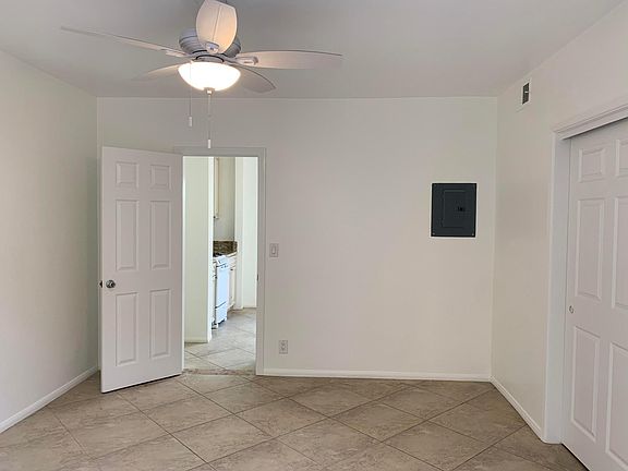 Bedroom with new ceiling fan and freshly painted walls.