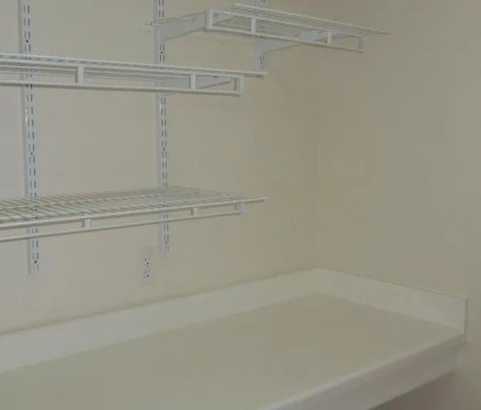 Folding counter plus wire storage on opposite laundry wall.