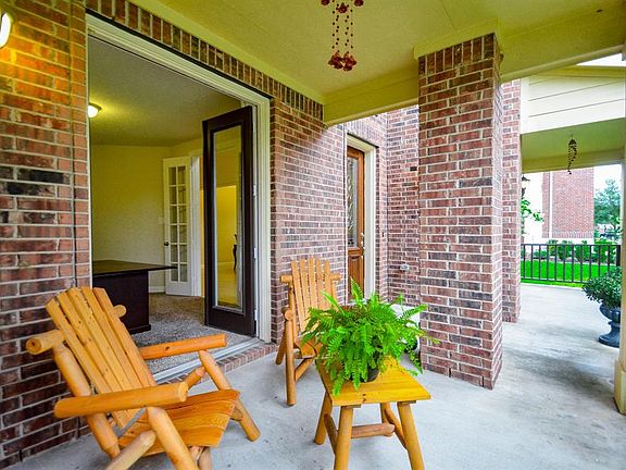 One of two quaint porches that opens to a tranquil study with double french doors.