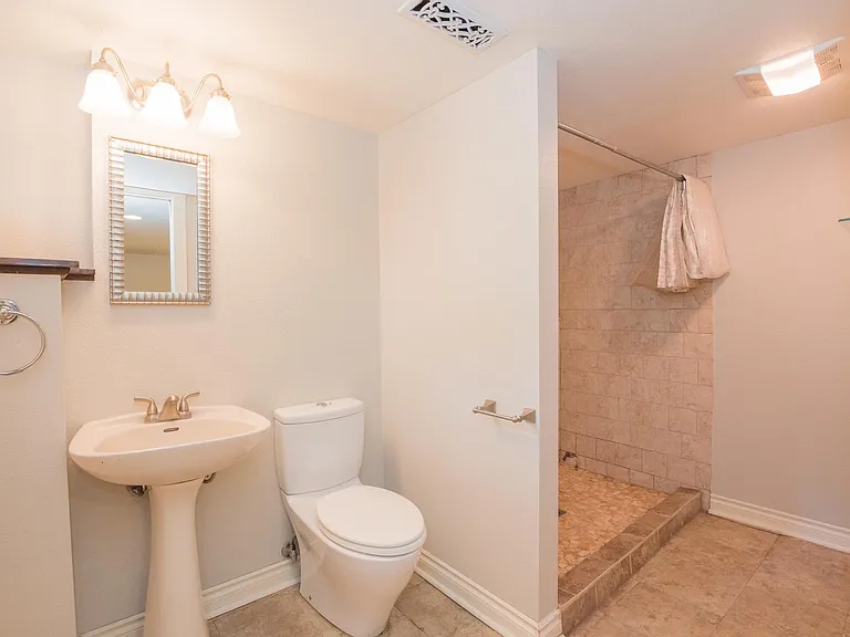 large walk-in shower with pebble tile
