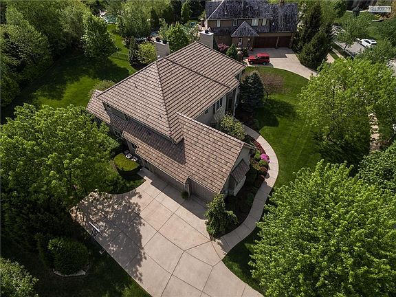 Concrete Tile Roof is 3 years NEW! 3 car garage with ample driveway space to back out, separate door for entry into the garage without opening garage doors. Access to the Lower Level from garage. Mature Trees, lovely walkway to the front door. This home is beautiful inside and out!