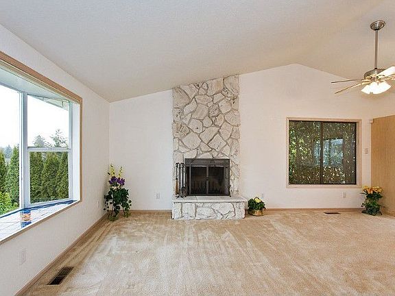 The granite-tiled entry (not seen in photo) welcomes you into this light and bright living room while the tile-seated bay window allows you to enjoy the serene surrounding neighborhood. Carpets have been freshly cleaned.