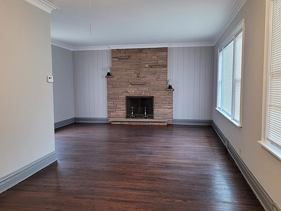 Living room has fireplace and refinished hardwood floor