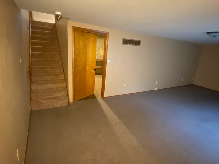 Lower level looking at the stairs and storage room.