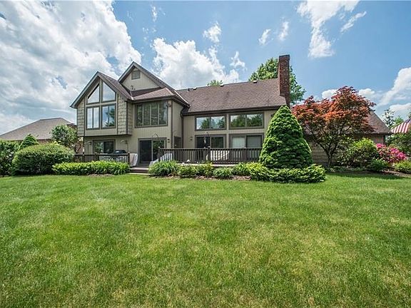 The beautiful flat yard, large deck, and ample windows make the back of the home just as stunning as the front!