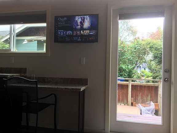 Flat screen TV, Front door facing south. Clear Storey windows above brings in lots of light.