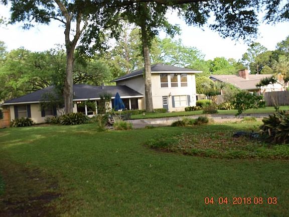 From the front side yard retreat, towards the drive way. Note the tree shaded garden and seating area off off the front porch.