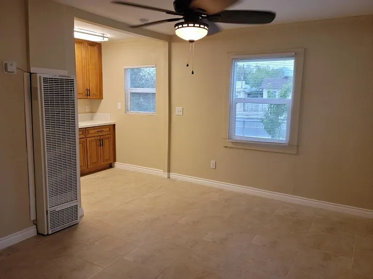 New tile floors for easy maintenance, new ceiling fan to keep air flowing, and in-wall gas heater for economical warmth in winter.
