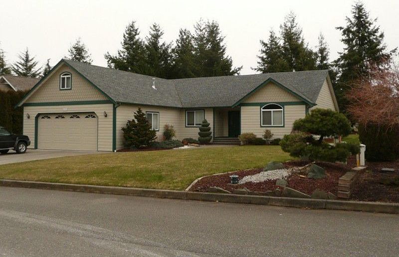 Photo of the front of the home. Low maintenance landscaping and in-ground sprinklers make lawn care 