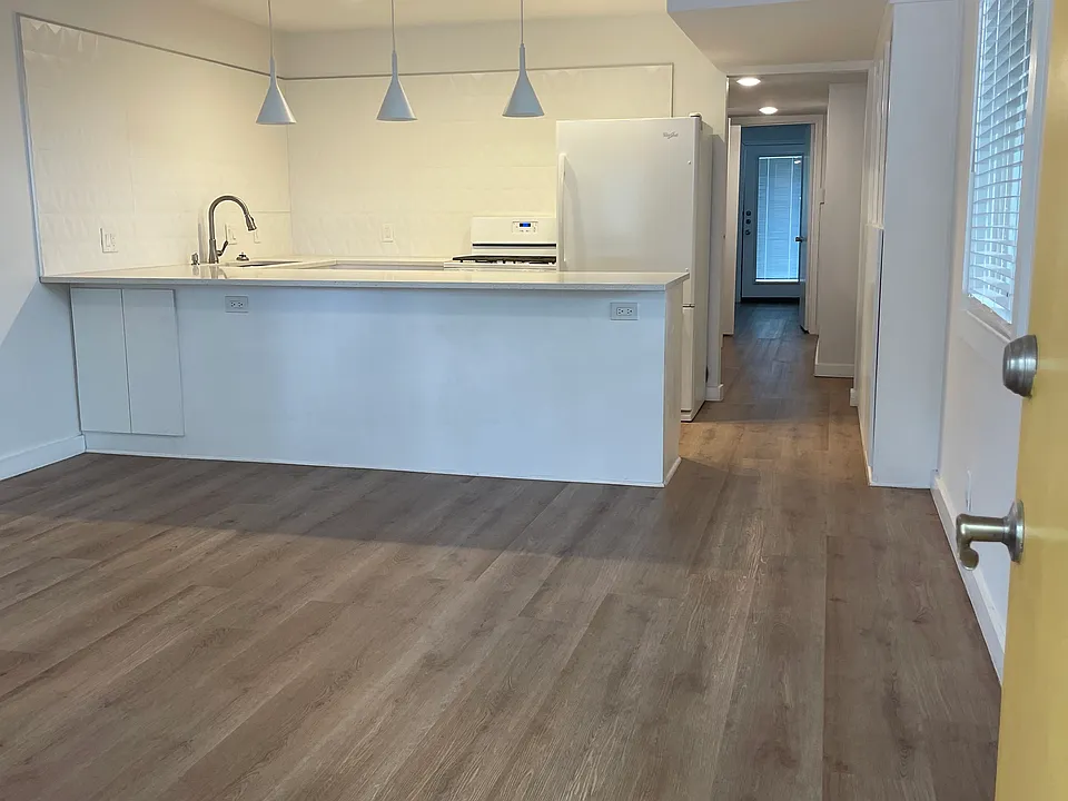 View of living room and kitchen from front door.