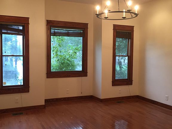 Large windows on front wall of living room #1.