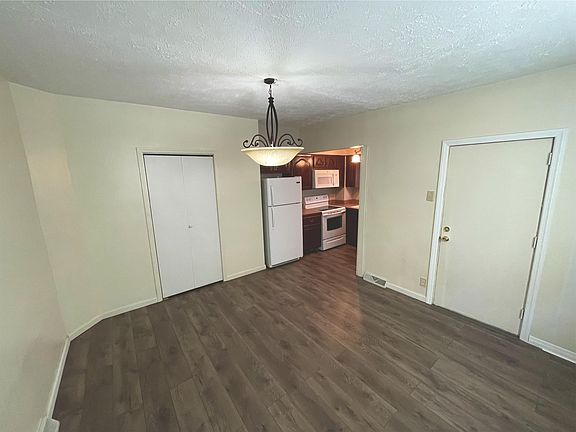 Ample dining room, beautiful floors, open to the kitchen. elegant light fixture.