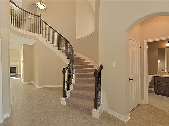 Entryway with wrought iron staircase