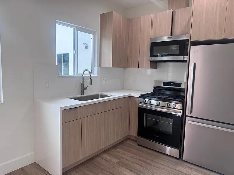 Full kitchen with window above the sink.