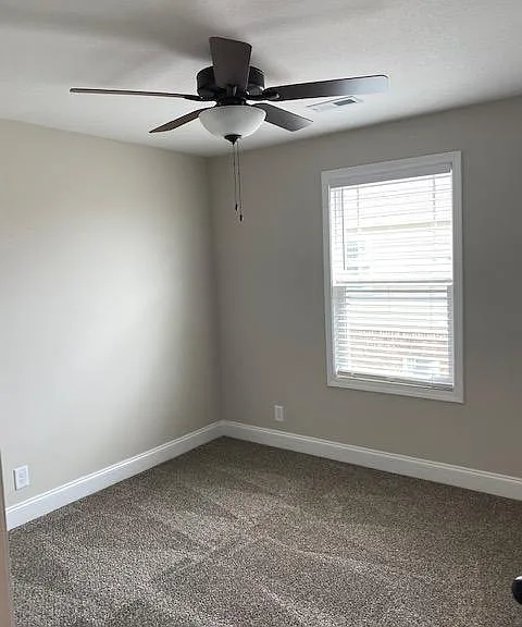 3rd bedroom with fan and closet