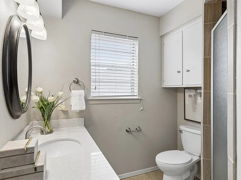 The primary bath features quartz countertops and a shower.