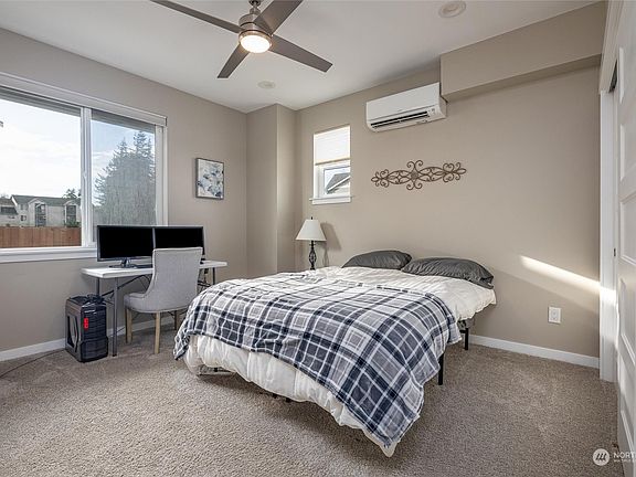 The cozy guest retreat just steps from the entrywayâ€”perfect for a warm welcome.>