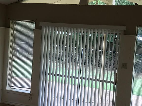 Second living area hosts wood laminate flooring and ceiling fan.