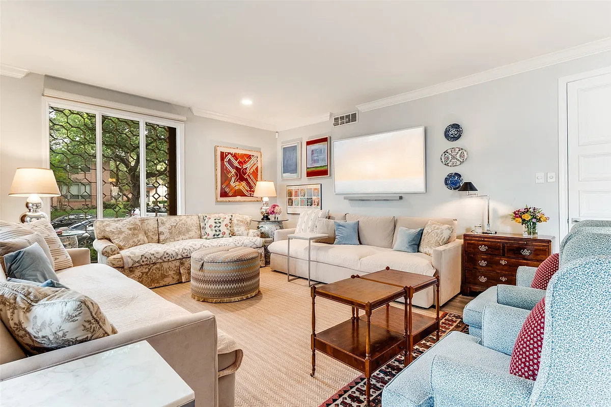 Living area featuring light-colored walls, crown molding, and recessed lighting - 6306 Bandera Ave #B