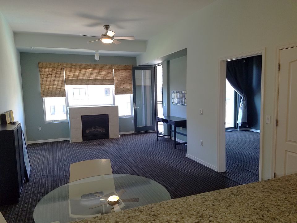 View of dining area, living room & large window (from entry door) (as partially furnished at current time)