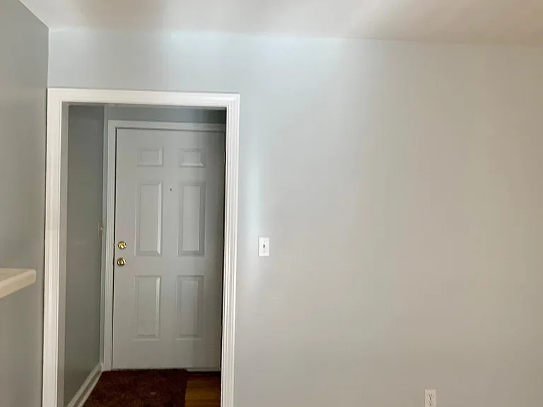 Front door with kitchen counter on the left