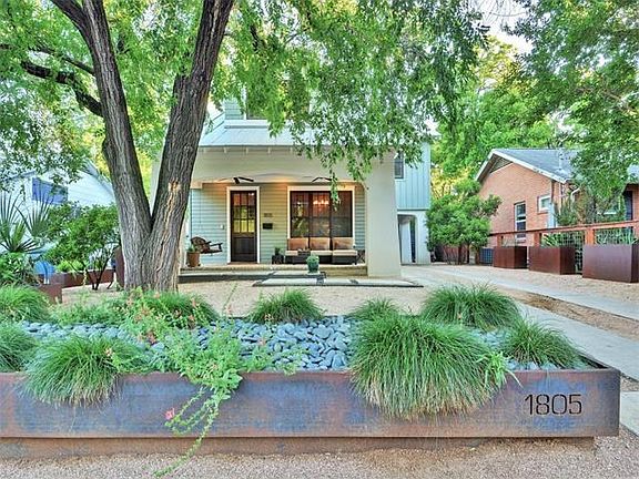 Steel planters, zero-scaping, drought tolerant landscape and a large oak tree welcome you home and invite you to relax.