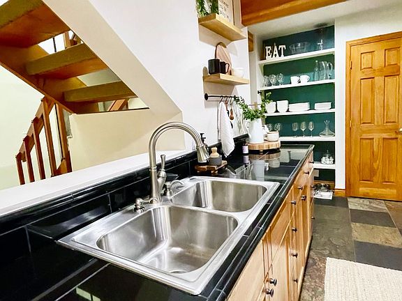 Kitchen with open shelving and beautiful beam