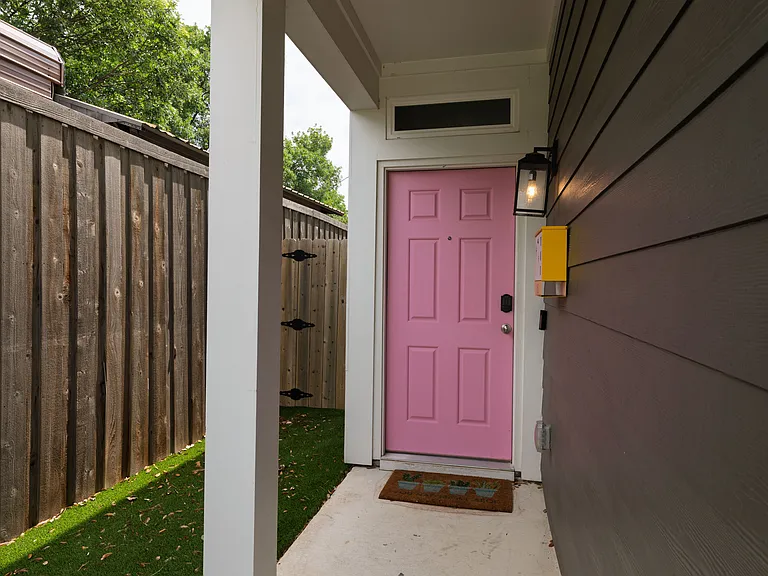 Welcome through a vibrant pink front door that adds a fun, inviting splash of color to your stay!