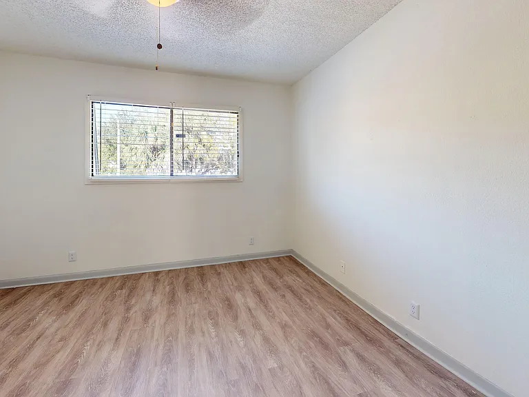 Step into this cozy, light-filled bedroom with sleek flooring.
