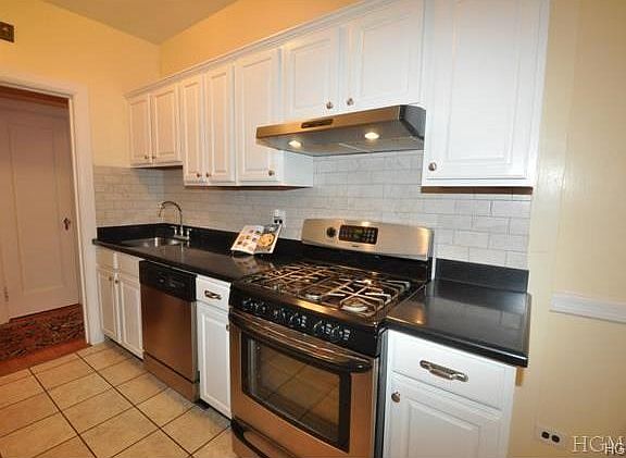 Updated Eat-in-Kitchen has granite counters and stainless steel appliances including a dishwasher, r