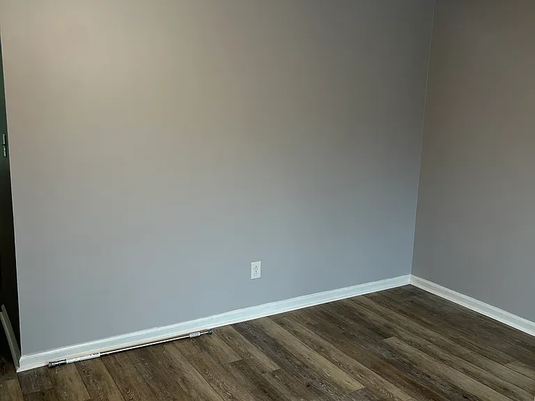 One of three bedrooms with windows and ceiling fans plus individual closets in each