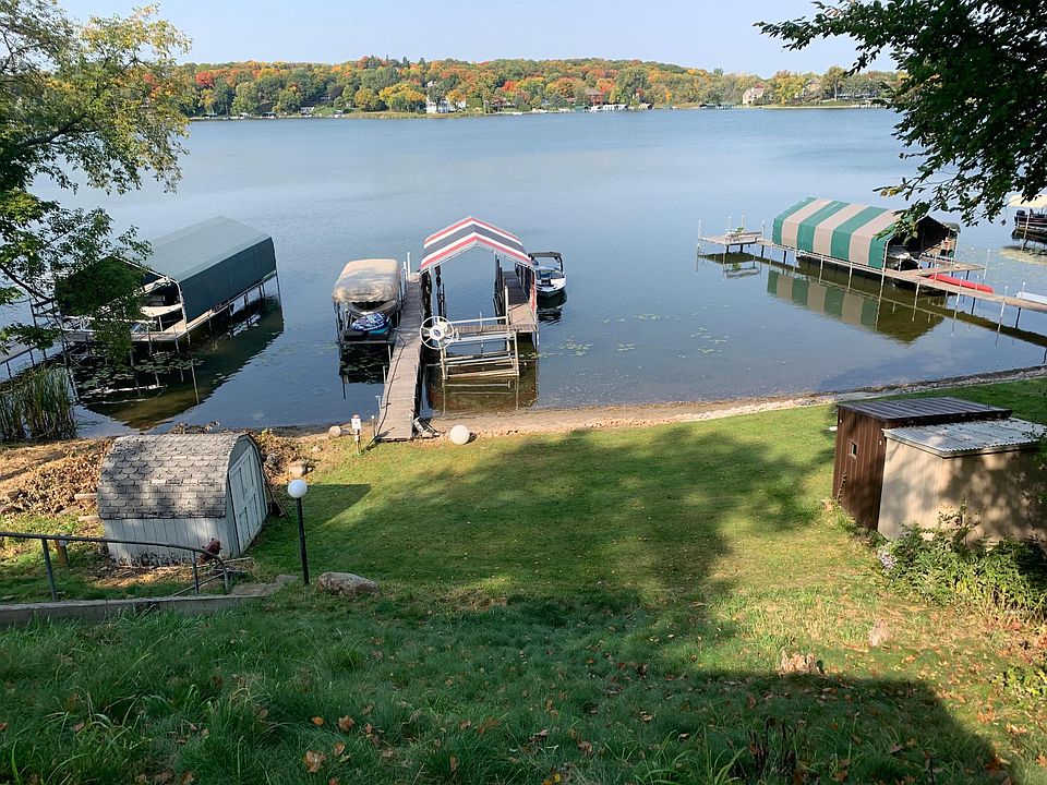 Sandy shore. Note, there is a new shed on the property. We do not have pictures of the new shed. Owners keep their boat under the stripe canopy. There is room for one boat next to it and a smaller lift for a boat approximately 4,500 lbs.