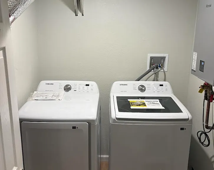 New washer and dryer on ground floor in laundry room