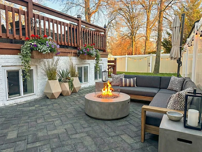 Fenced backyard with updated pavers and space for pets, outdoor dining, or lounging.