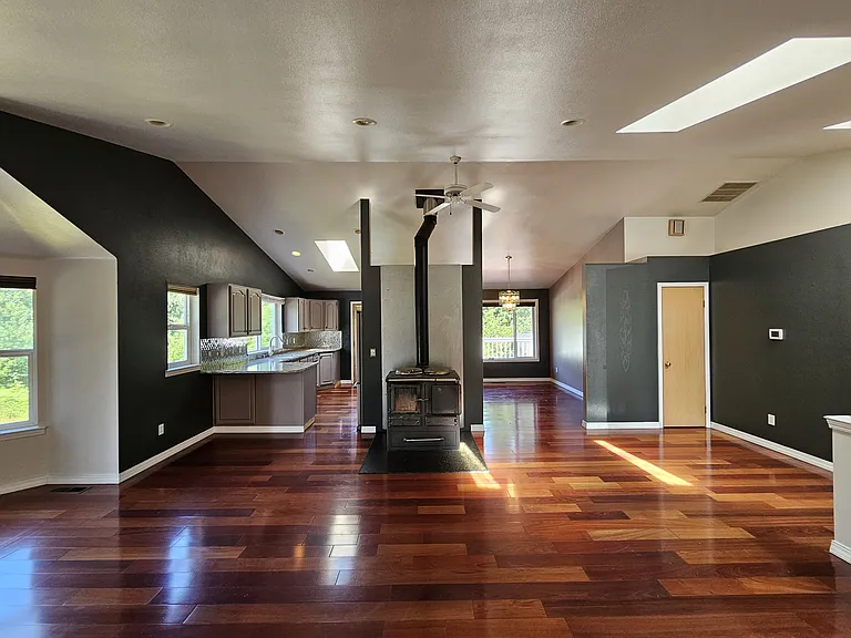 Open floor plan with wood burning stove.