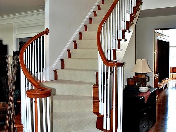 Two Story Foyer With Curved Staircase