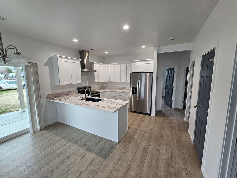 Bright Kitchen with island. Hard surface counters and self closing cabinet doors and drawers.