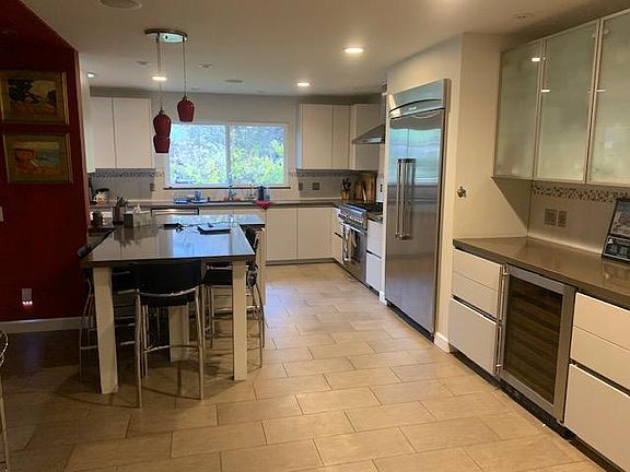 Another angle of the kitchen, island and dry bar. The window looks out on the back yard.
