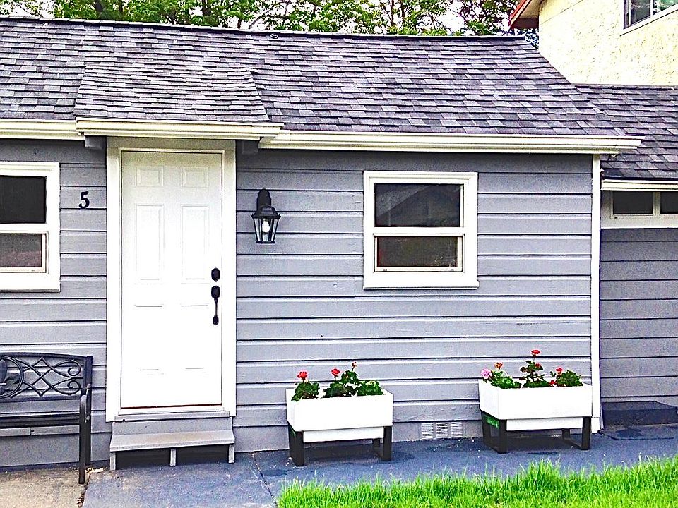 Flower planters or herb garden with park bench