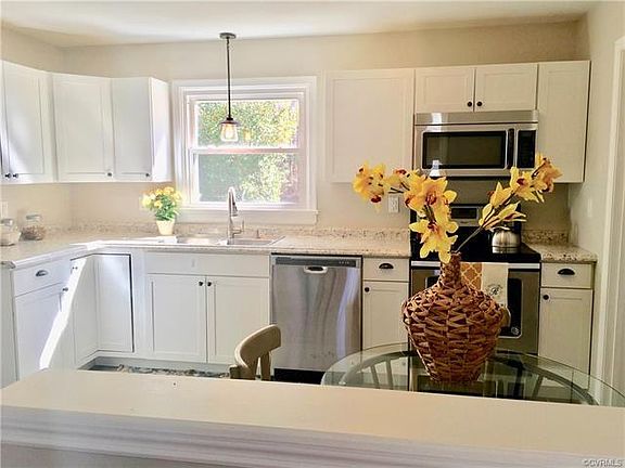 Updated kitchen with stainless steel appliances, opens up to the living room for a open concept floor plan