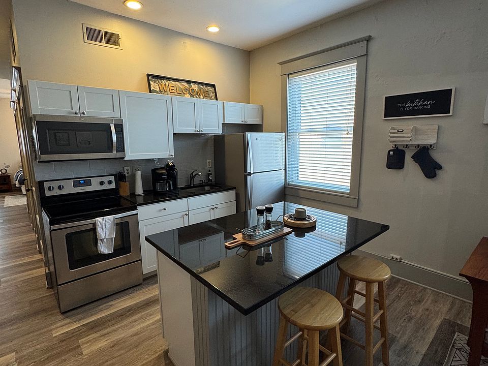 Gourmet kitchen with island, granite counters and stainless steel appliances