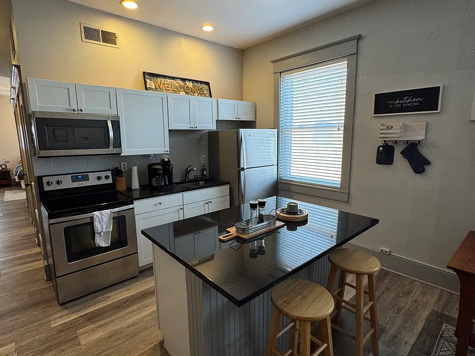 Gourmet kitchen with island, granite counters and stainless steel appliances