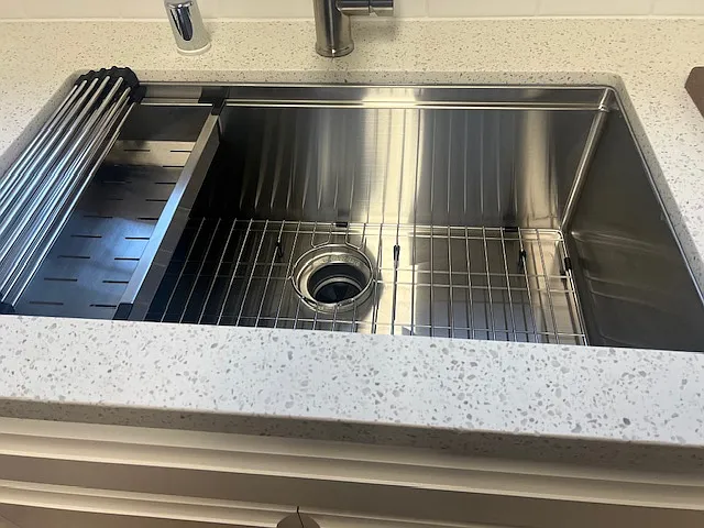 newer stainless steel sink w/bottom grid,