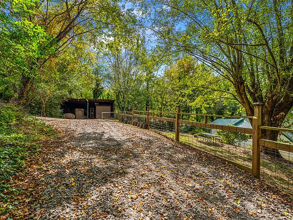 Parking area behind the home with storage shed for parking/outdoor storage of bikes/kayaks/etc.
